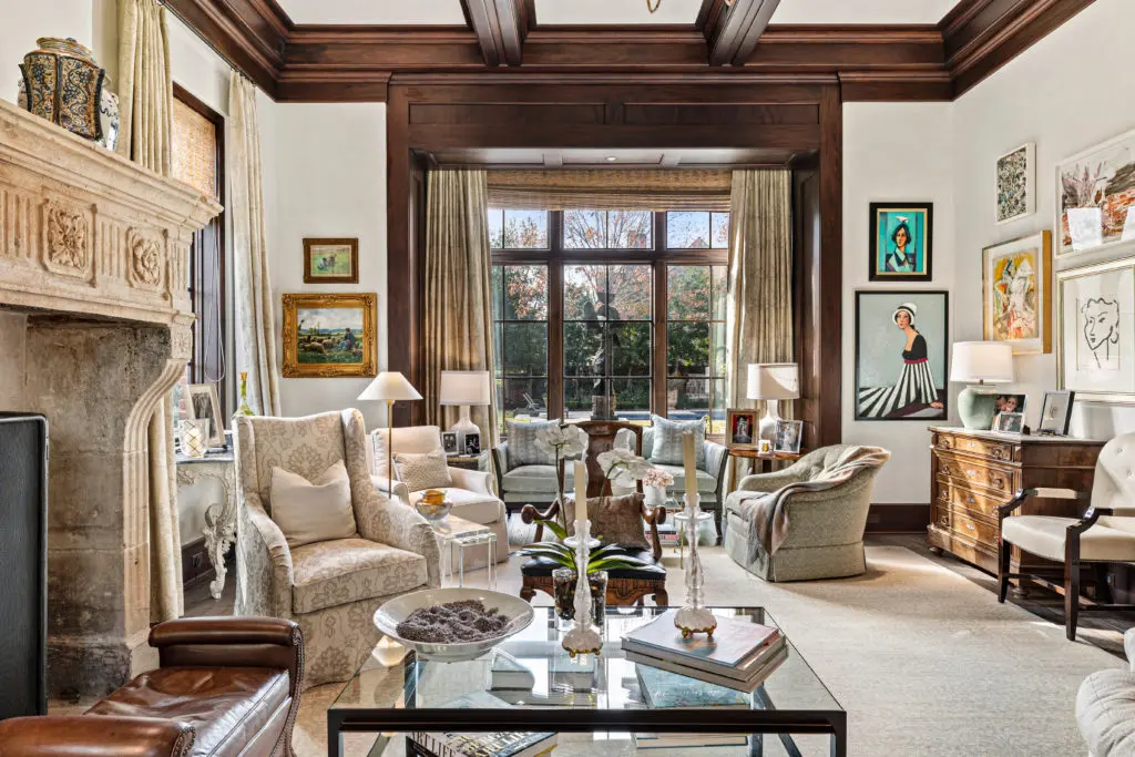 The living room in Frances and Tony Buzbee's home features one of the five wood-burning fire places in the River Oaks mansion. (Photo by Courtesy of Josh Gremillion for Douglas Elliman)