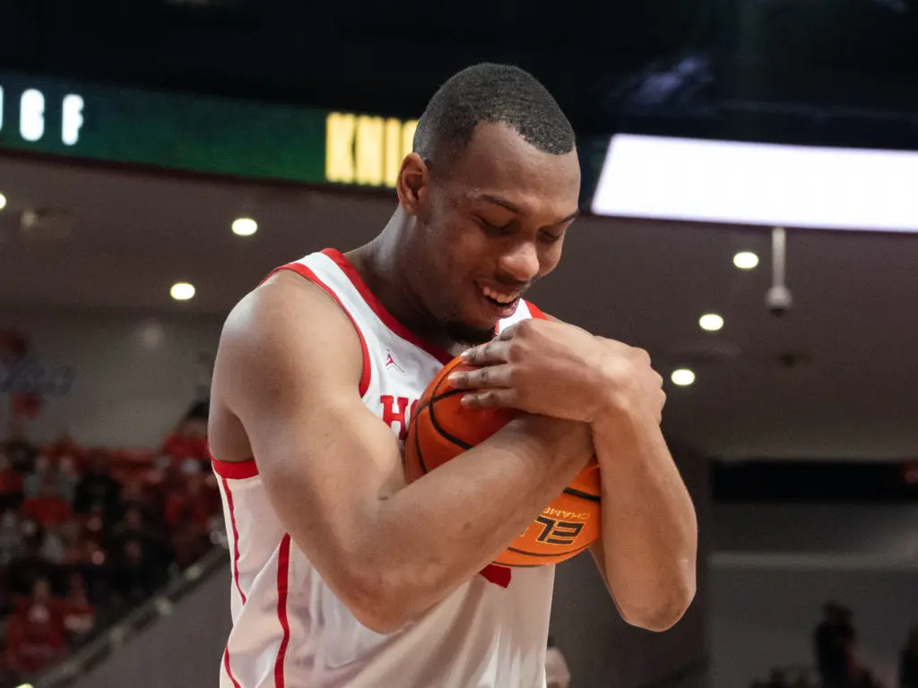 Fabian White Jr. cradled the basketball after winning his 110th game, more than any other player in the long, impressive history of the University of Houston basketball program. (Photo by F. Carter Smith)
