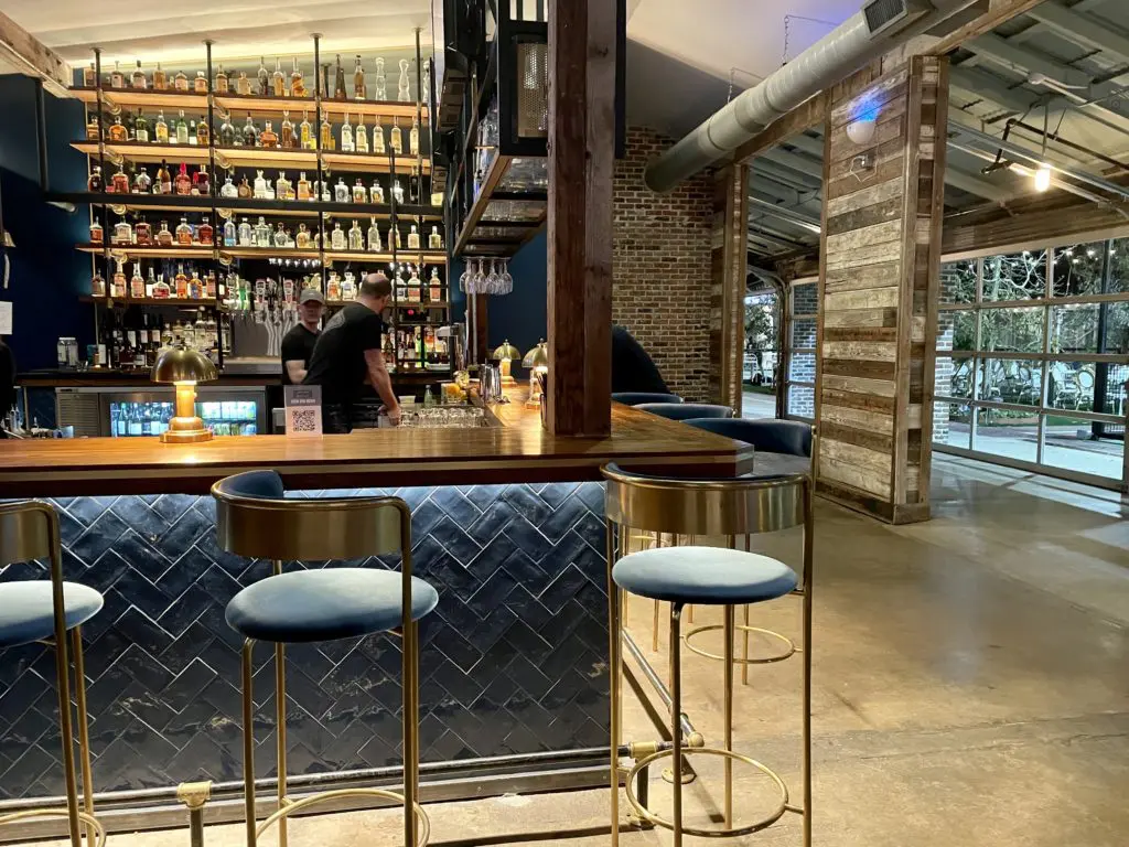 Courtside Kitchen's bar area opens onto lush patio and pickleball courts. (Photo by Courtney Dabney)