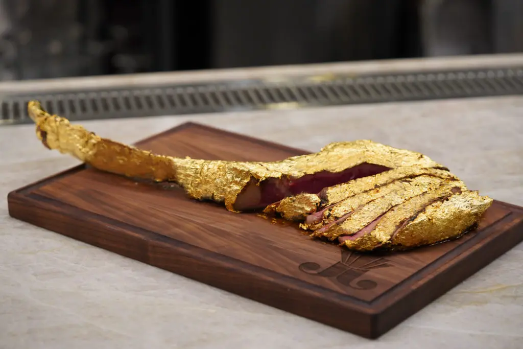 The 34-ounce USDA Prime gold tomahawk ribeye wrapped in 24k gold leaf is highlight of the menu at Juliet. (Photo by In-House Social)