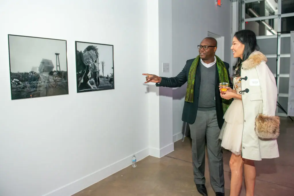 Dipo Alli and Yuan Zhang admire Modine's work on the opening night of his exhibition at Alta Arts.