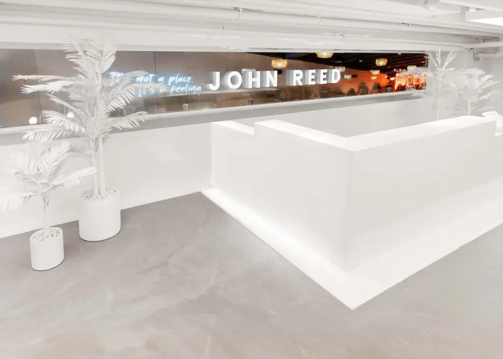 A slick, stark space helps cleanse your visual palate before entering John Reed's color-drenched gym.  (Photo by JOHN REED Fitness)