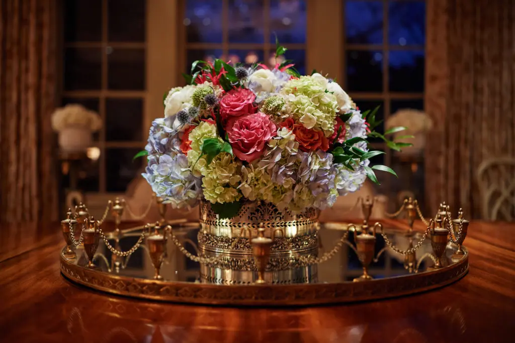 Stunning flower arrangements covered the dining table and buffet (Photo by Jonathan Zizzo )