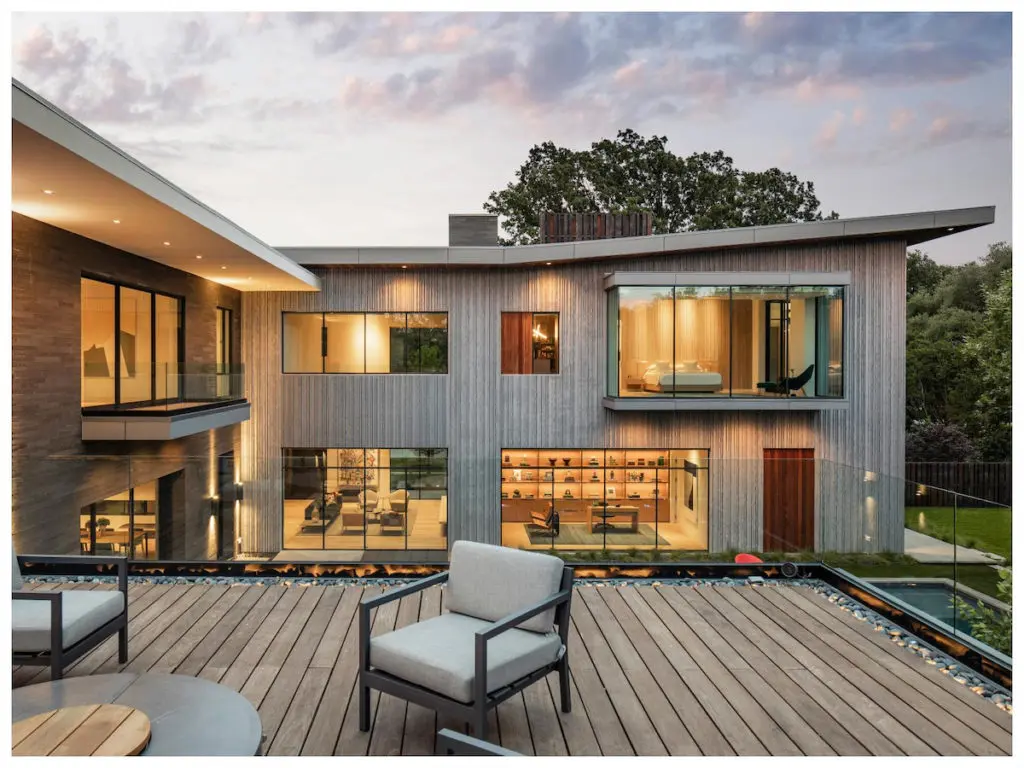 The home's exterior features precast concrete, steel, and basalt stone. 