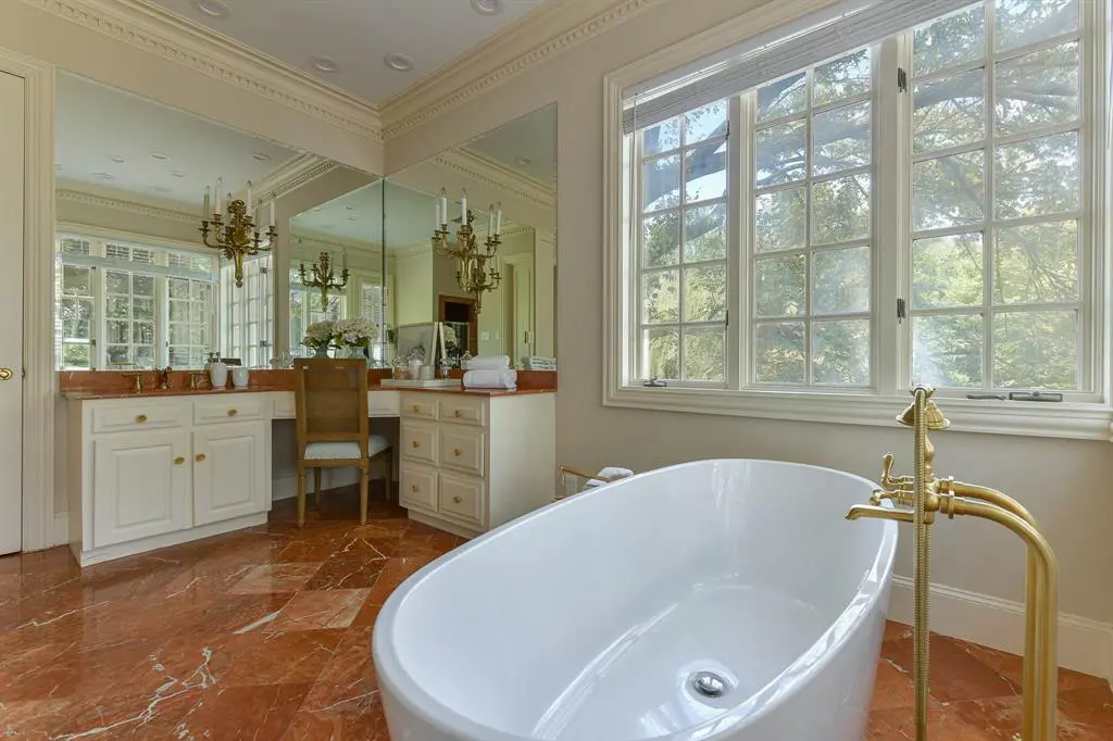 The master suite includes two separate marble bathrooms and a walk-in closet. 