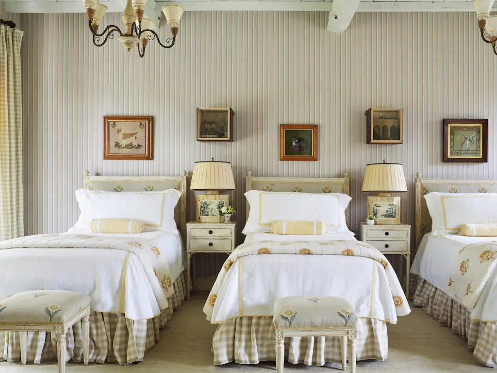 Chelsea Textiles headboards upholstered in sunflower embroidered fabric. Les Indiennes quilts are also printed with sunflowers. (Photo by Tria Giovan)