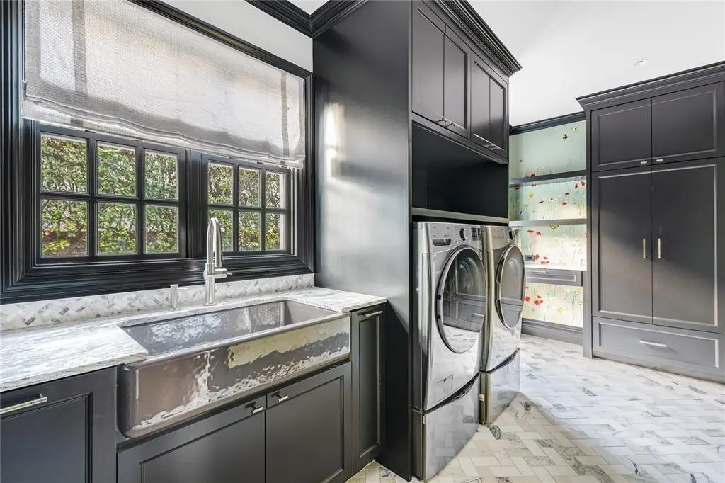 Hand-painted wallpaper by Fromental still serves as the backdrop for the ultra-chic laundry room. (Photo by Costa Christ Media)