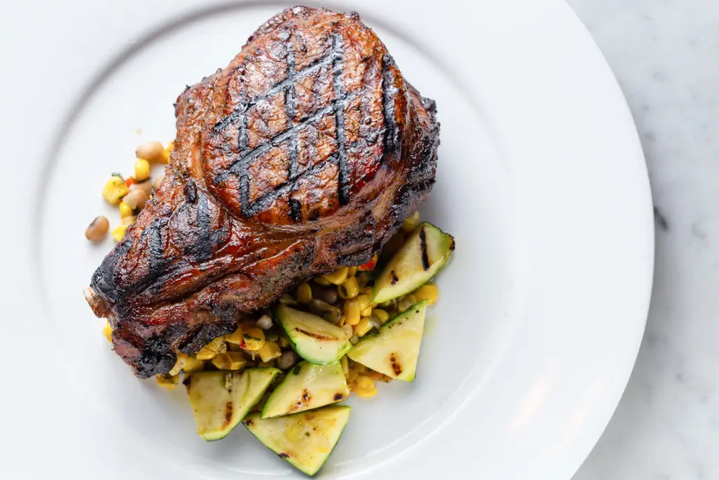 New to the Brasserie 19 menu is the Sakura pork chop with sumac glaze, roasted corn succotash, purslane, squash. (Photo by Andrew Hemmingway)