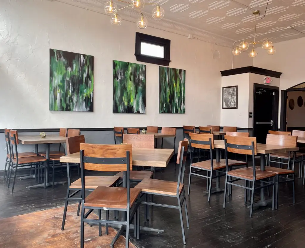 The secondary dining room topped by original tin tiles. Photo by Courtney Dabney.