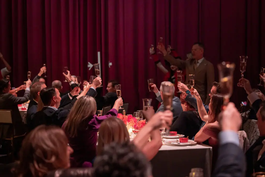 Dinner on Stage attendees toast the evening. (Photo by Thomas Garza Photography)