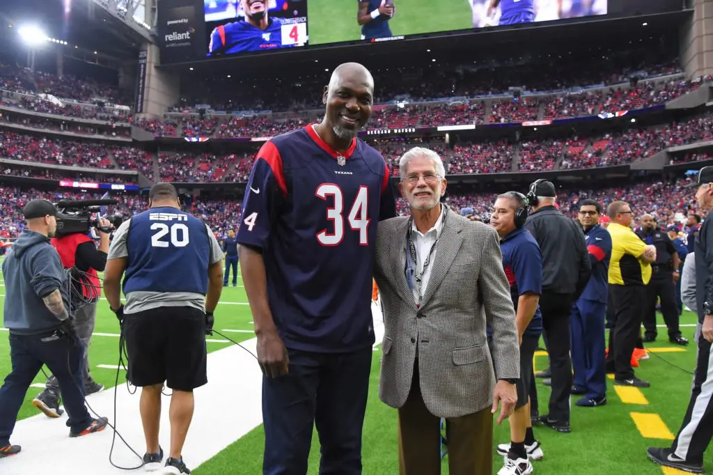 Team physician for the Astros, the Houston Texans and the Houston Rockets on the sidelines of a Texans game with Rockets star Hakeem Olajuwon. (Courtesy photo)