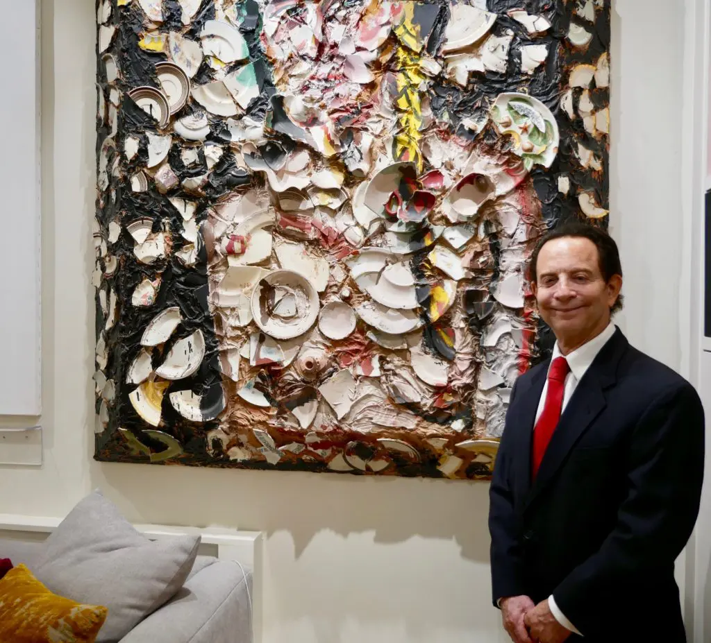 Lester Marks was named Houston's ambassador to the arts by Mayor Sylvester Turner and is a past Art League Houston Patron of the Year. Shown here, Marks with an early plate painting by University of Houston graduate painter/filmmaker, Julian Schnabel. 