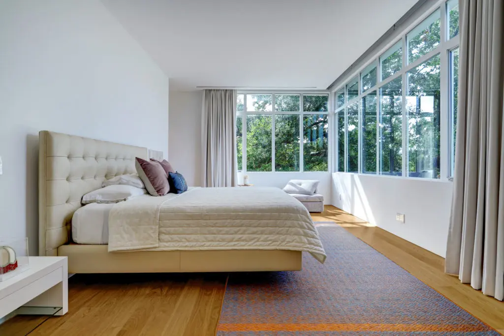 The primary bedroom on 3842 Piping Rock enjoys a view of the treetops. (Photo by TK Images)