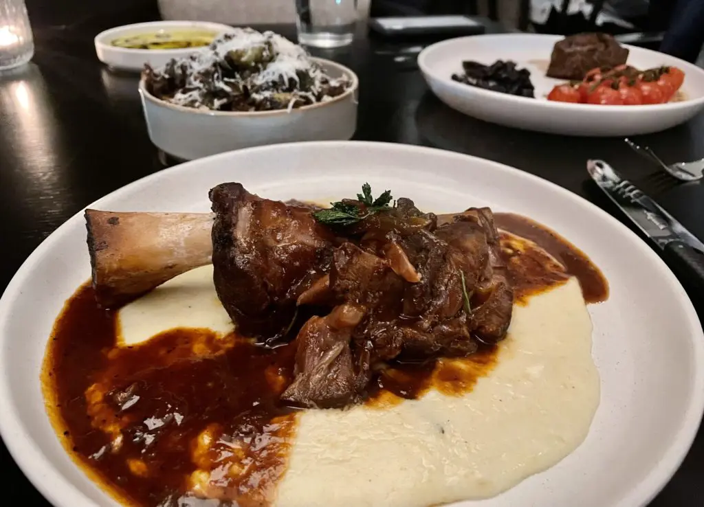 New braised lamb shank with parmesan polenta at il Modo. Photo by Courtney Dabney.