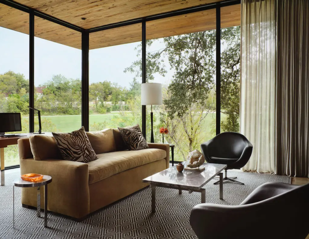 Weldon Turner designed the homeowner's office as a treehouse-like retreat overlooking the land. The cedar ceiling is extended past the windows to the outside. Furnishings are from the homeowner's previous house. (Photo by Lisa Petrole)