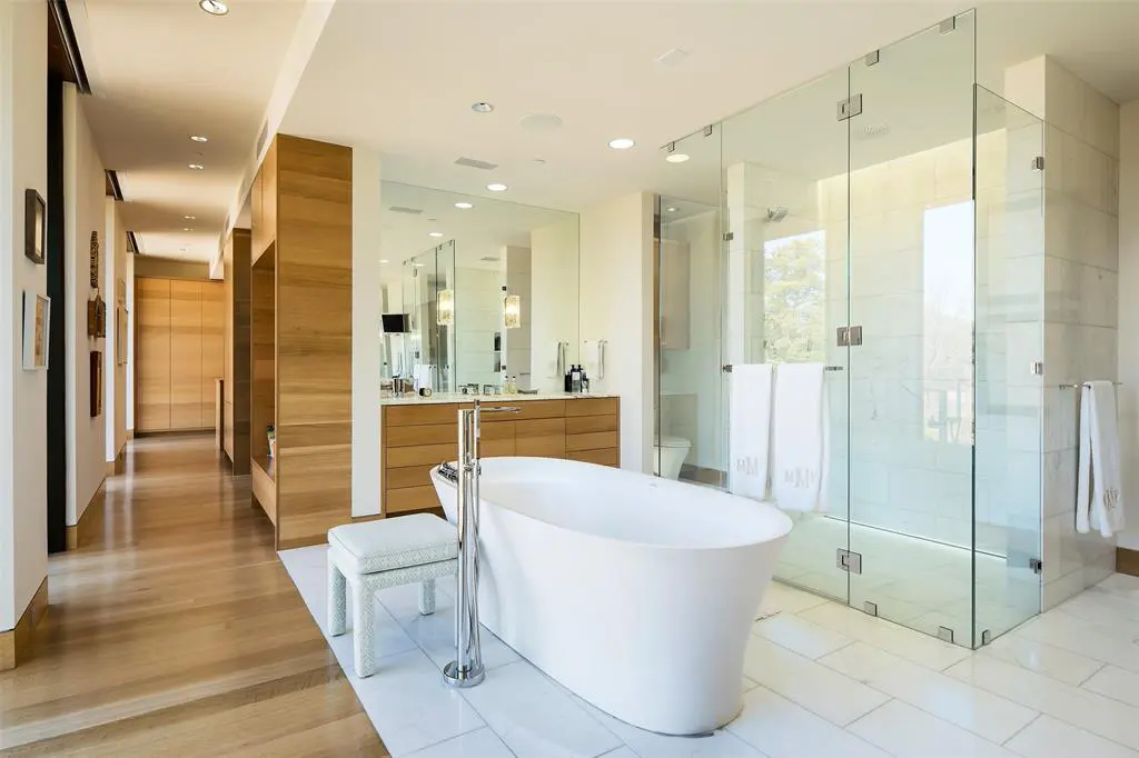 A freestanding tub sits at the heart of a master bathroom. 