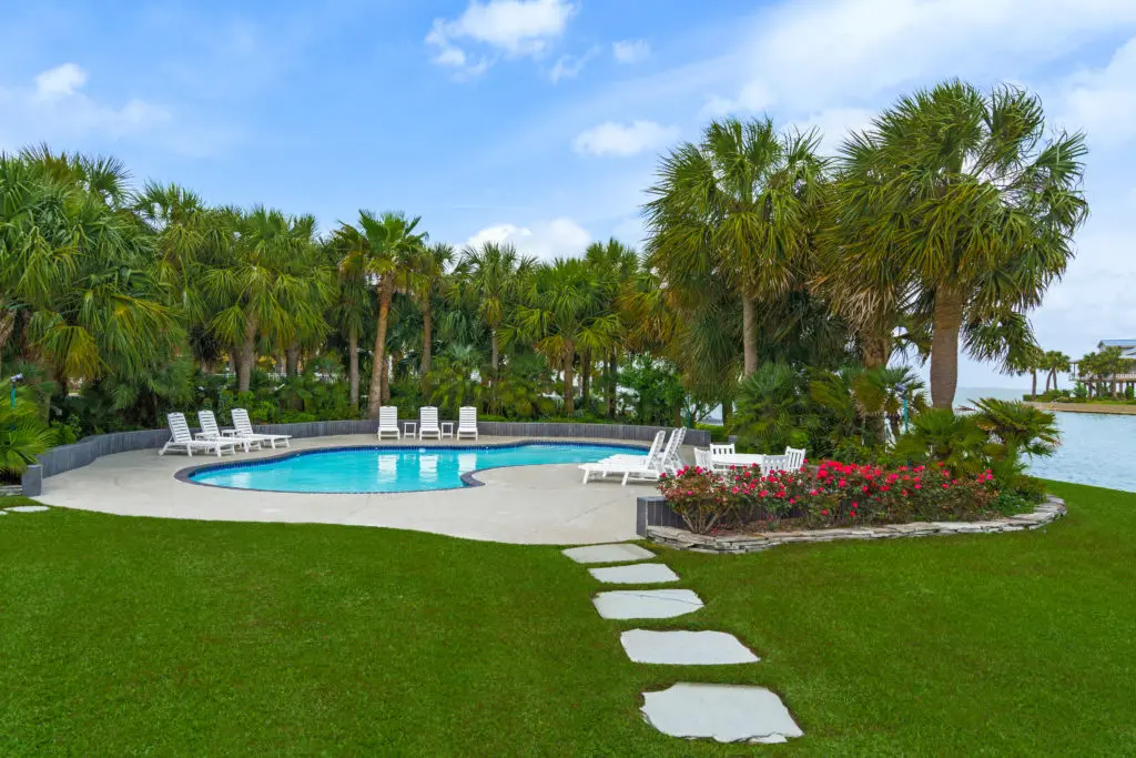 Mature landscaping adds an ambience of resort living to the property at 16502 Bayfront Drive in Jamaica Beach  (Photo by Sonya Bertolino for Douglas Elliman Realty)