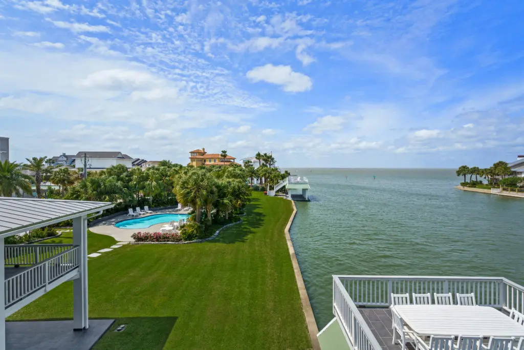 Manicured lawns and mature landscaping highlight 16502 Bayfront Drive (Photo by Sonya Bertolino for Douglas Elliman Realty)