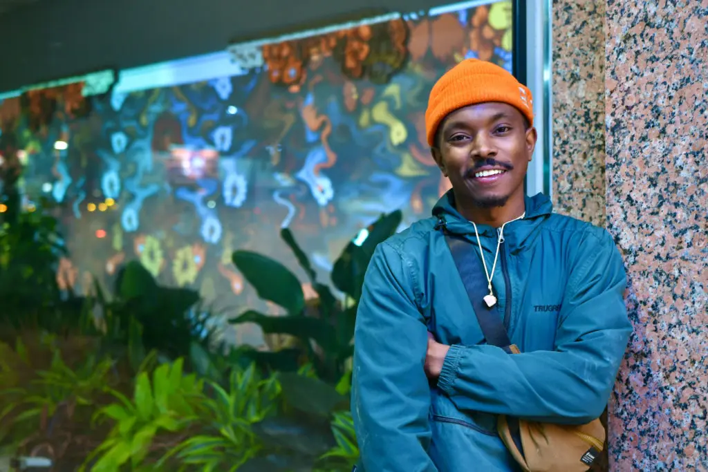 Preston Gaines with his "Fantasy Landscape," 2022, at the Ion. (Photo by Alex Montoya)