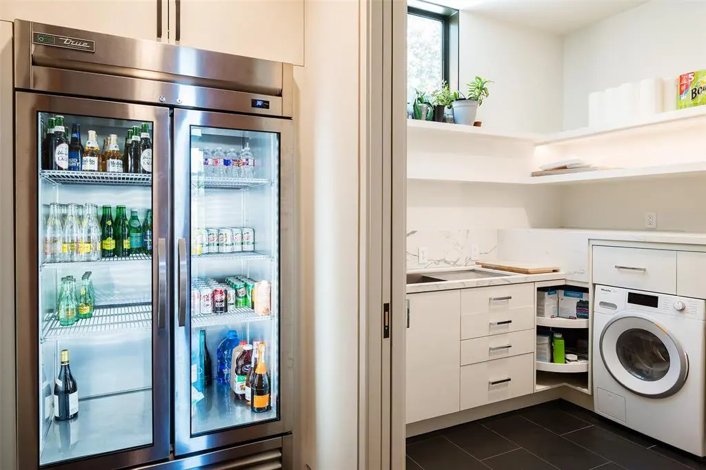 The laundry room comes equipped with its own refrigerator. 