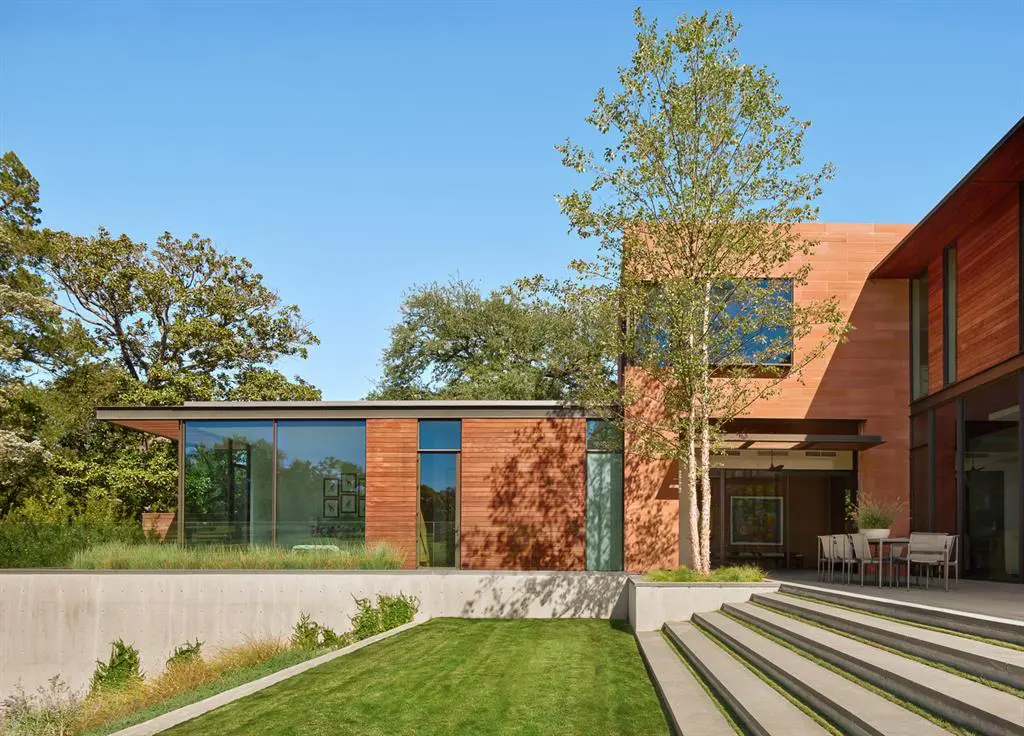 The lawn is meticulously kept and manicured to compliment surrounding  nature. 