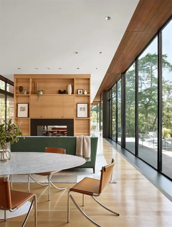 A dual-sided fireplace connects two living areas. 