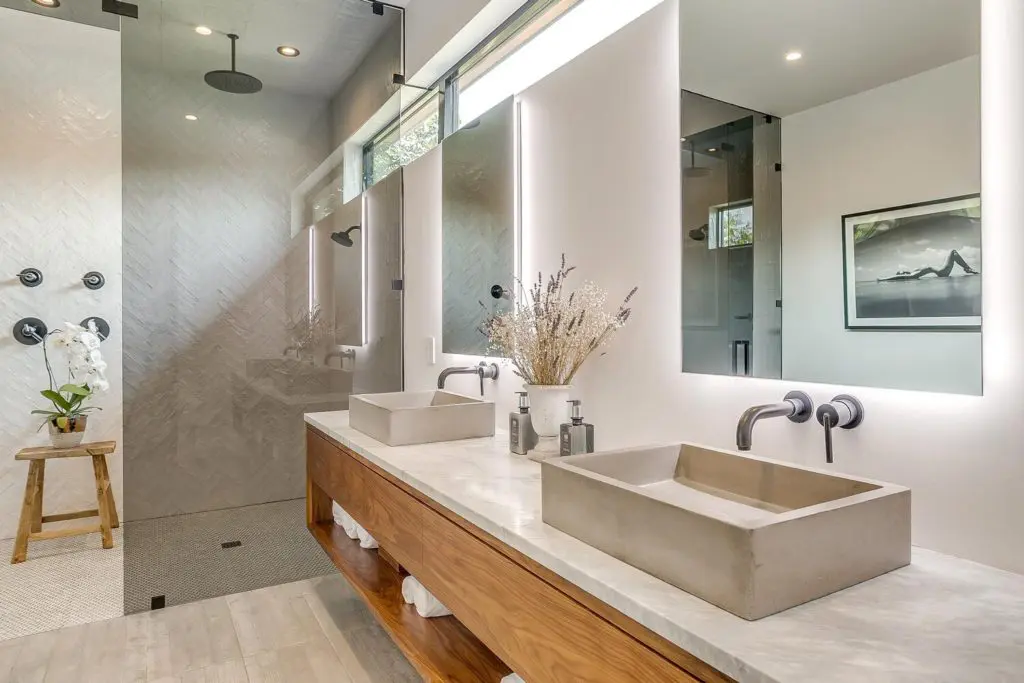 Primary ensuite with double sinks and double rain head shower.