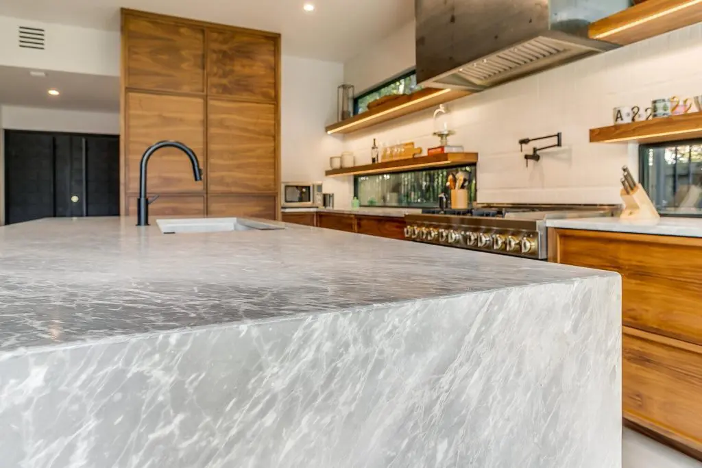 The center island is part function and part fantasy with its leathered granite waterfall edge.