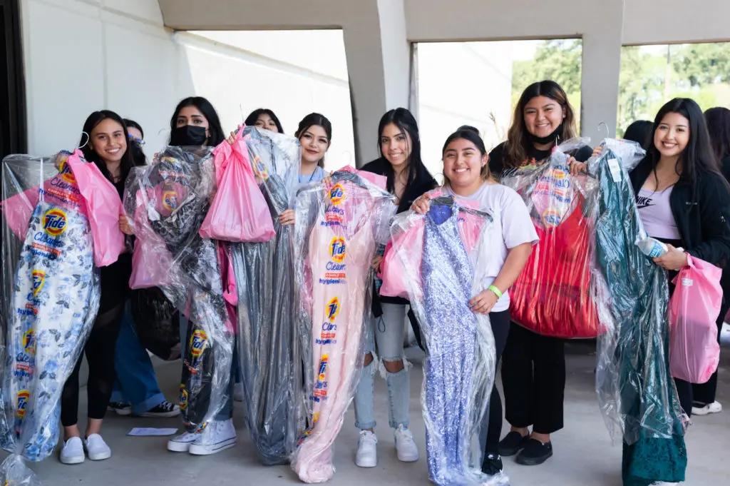 A happy group of teenagers leave the Prom Boutique with their gowns. Houston-area Tide Cleaners makes sure each gown is cleaned and ready to go. (Photo by Sara Blair Design Photography)