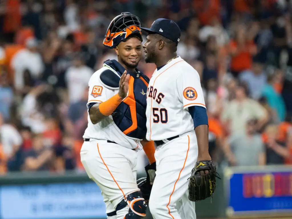 Hector Neris got plenty of love from catcher Martin Maldonado after a scoreless inning. (Photo by F. Carter Smith)