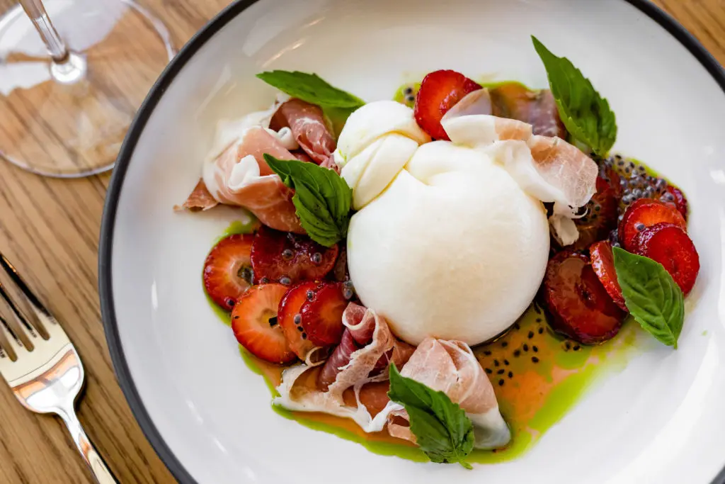 The new Marmo Italian restaurant on lower Westheimer features this burrata salad with strawberries and prosciutto di Parma, topped with Minus 8, the vinegar made from ice-wine grapes. (Photo by Kirsten Gilliam)
