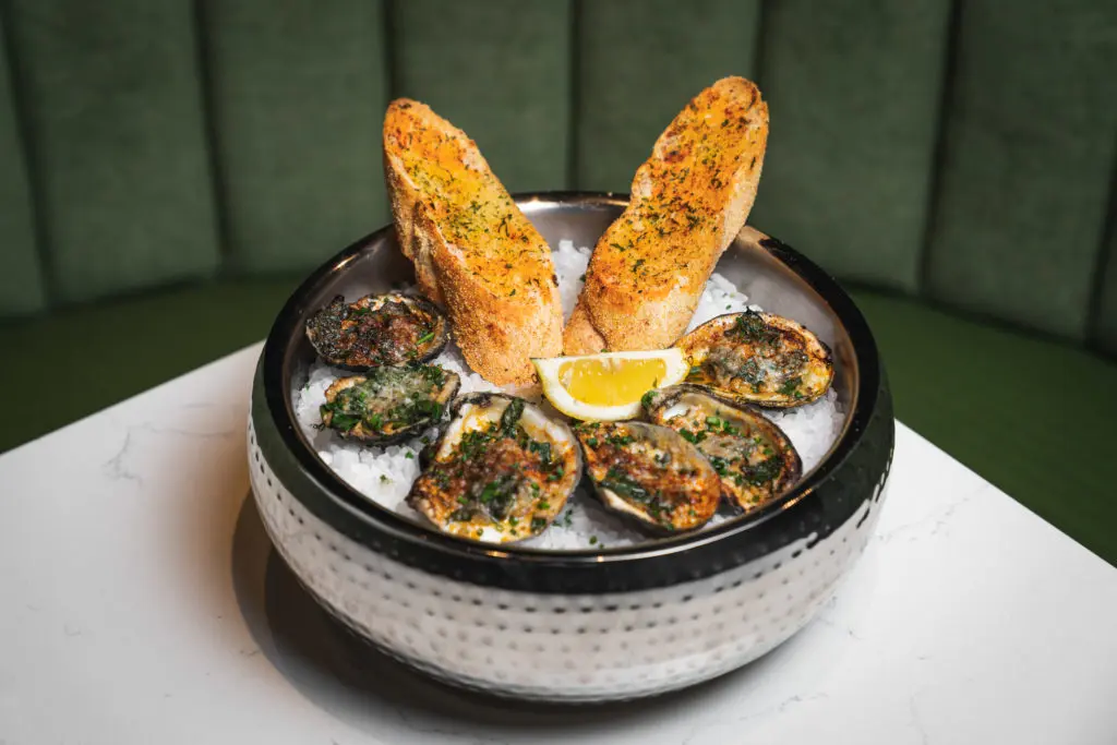 The Warwick's charbroiled Gulf Oysters.  (Photo by Raydon Creative)
