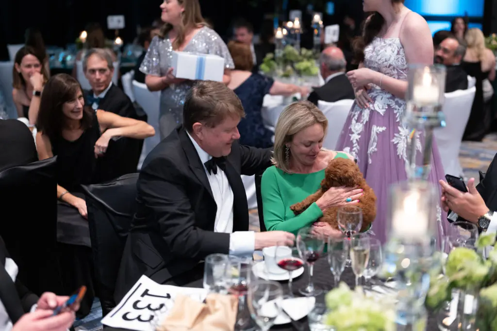 Embry & Robyn Canterbury win the goldendoodle puppy in the live auction at the JDRF Promise Ball  (Photo by Daniel Ortiz)