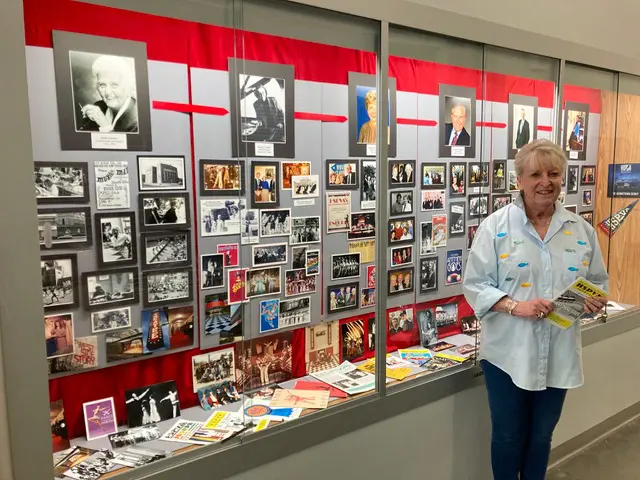 Mary Martha Lappe, A Co-Founder of HSPVA, stands proudly in front of her completed 5-week project which showcases  important moments that occurred during each of HSPVA’s six principals' tenures. The archives and photos on display were collected as part of the school's 50th year celebration, and can be seen inside the high school.