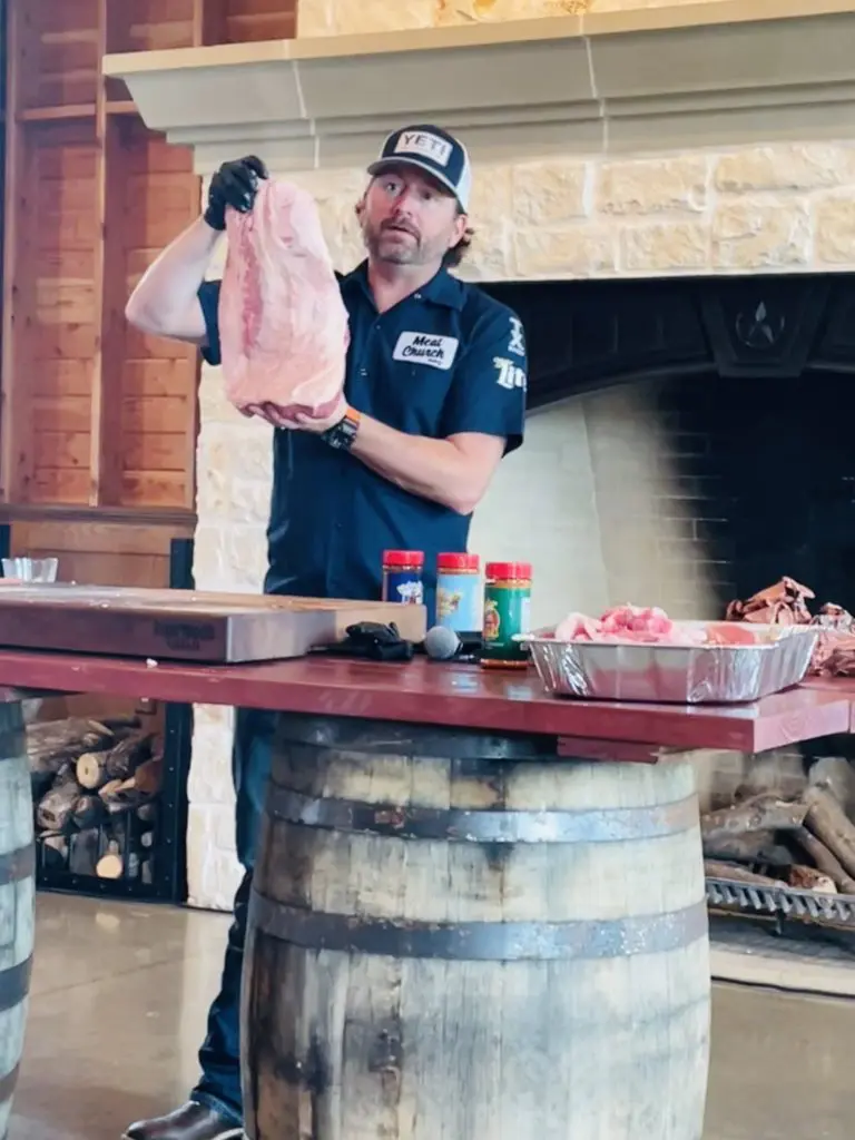 Matt Pittman holds up the fully trimmed brisket, ready for the smoker. Photo by Courtney Dabney.