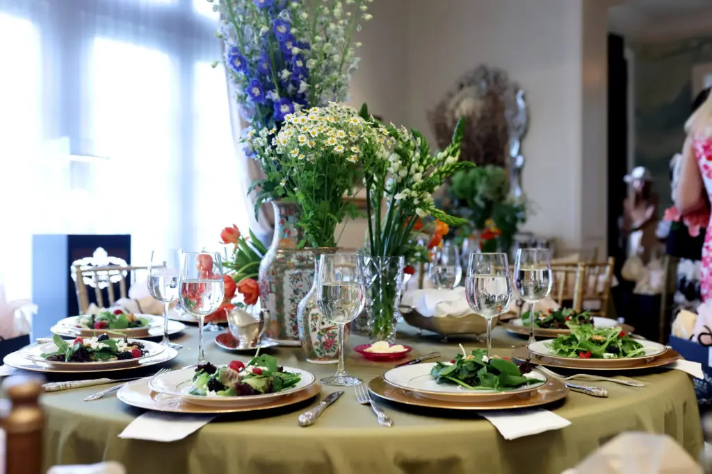Table settings for the spring fashion luncheon where designer Amir Taghi did not only the fashions but also the flowers for the tabletops. (Photo by Quy Tran)