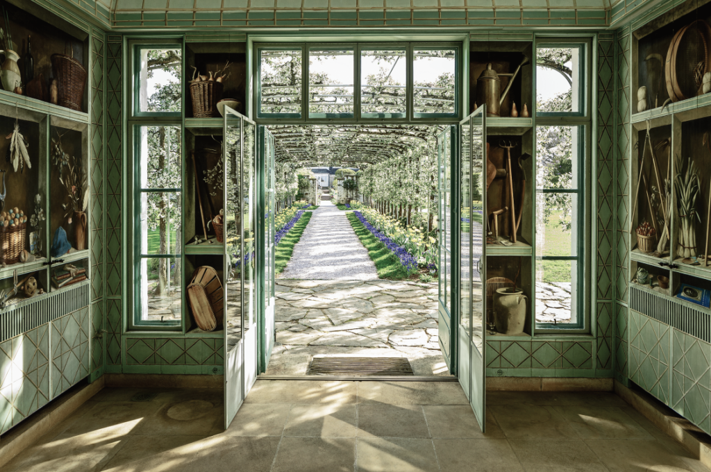 Inside the central pavilion of Bunny Mellon’s formal greenhouse at Oak Spring with Fernand Renard trompe l’oeil paintings.
