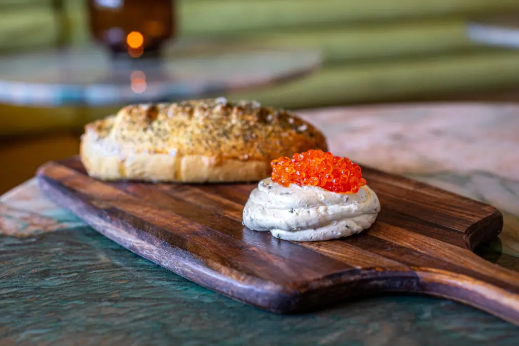 The Japanese milk bread arrives warm with a dollop of whipped European-style butter topped with smoked trout roe. (Photo by Jenn Duncan)