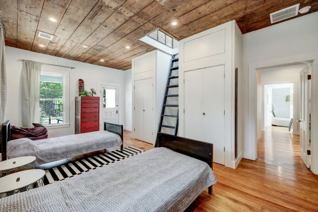 Original flooring and ceilings are preserved in the secondary bedrooms in the house at 717 East 21st St. in The Heights (Photo by TK Images)