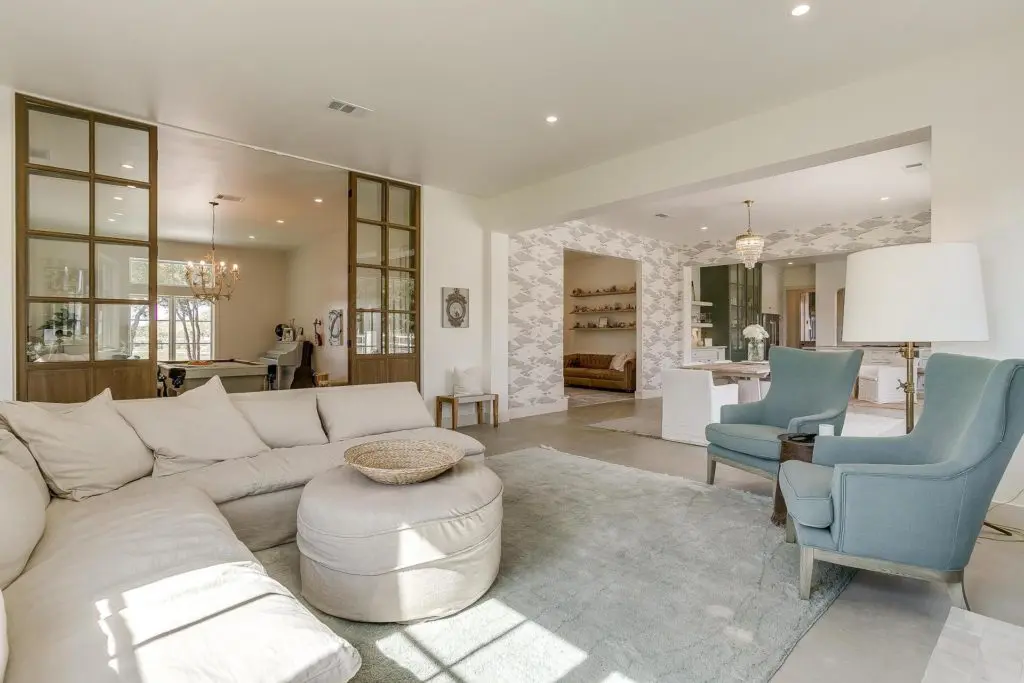 Muted tones in the living room and the game and music room connected.
