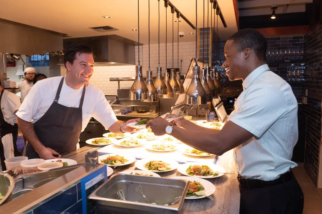 Bludorn executive chef Aaron Bludorn teams with Houston Ballet demi soloist Naazir Muhammad for the entrée at Houston Ballet's 'Raising the Barre' fundraiser held at Bludorn. (Photo by Wilson Parish)