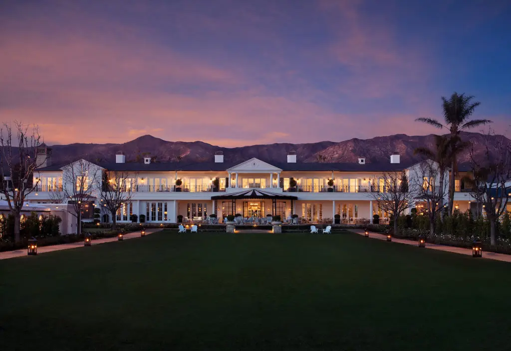 The Great Lawn of Rosewood Miramar Beach resort at dusk. 