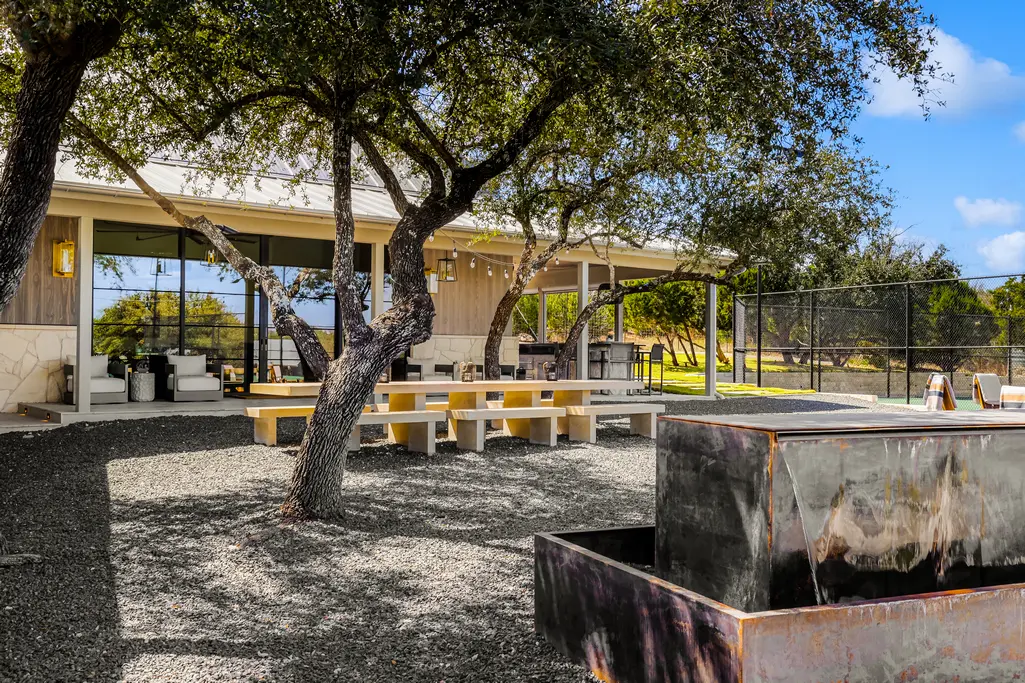One of many outdoor entertaining areas complete with a water feature at 8 Oaks in the Texas Hill Country  (Photo courtesy of Douglas Elliman Real Estate)
