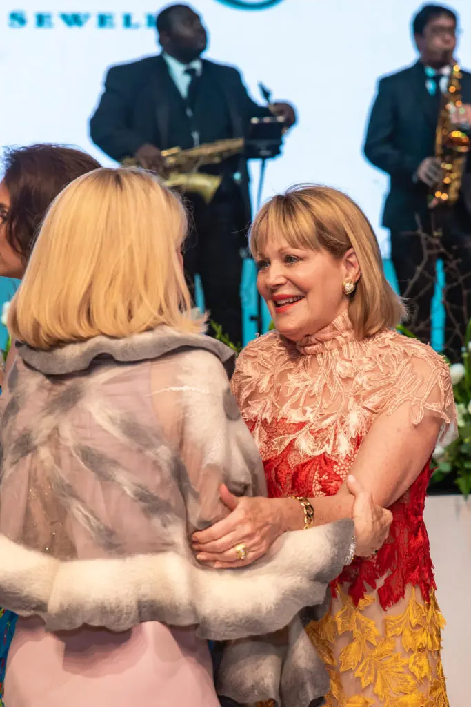 A warm embrace between former Junior League of Dallas ball chairs. (Photo by Tamytha Cameron and Celeste Cass)