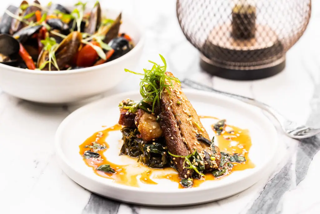 The Korean BBQ Pork Belly is a highlight of the District Dallas menu. (Photo by Kathy Tran)