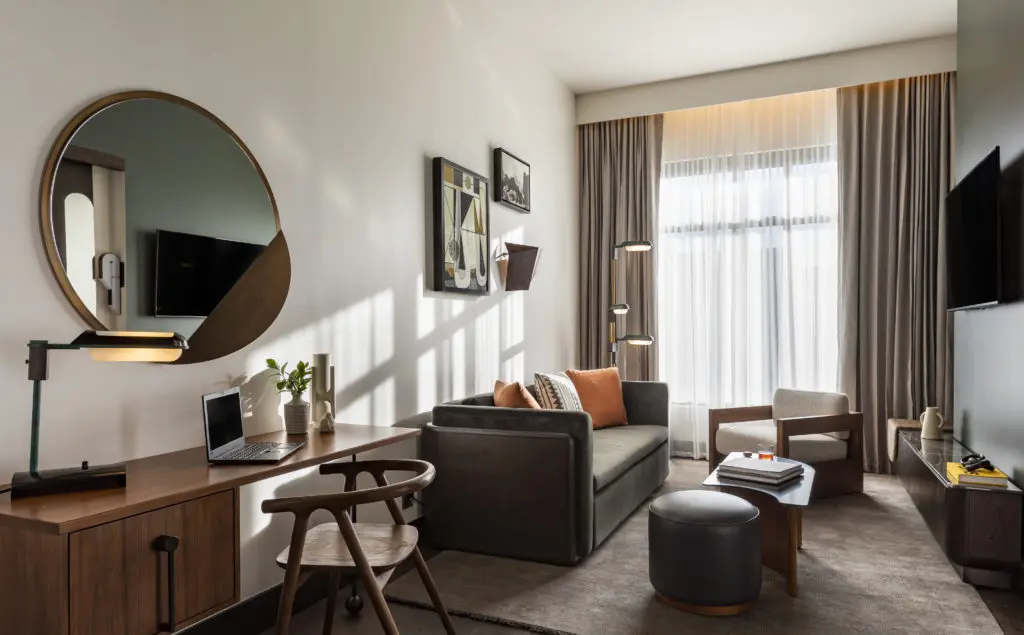 The Mile High Suite at Thompson Denver includes a lounge area and desk. (Photo by Julie Soefer)