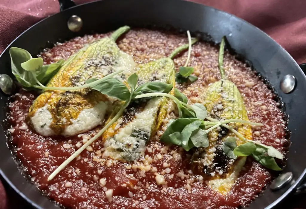 Squash blossoms in arrabbiata sauce stuffed with a mixture of ricotta anchovy and pecorino are just one of the interesting Tre Mogli dishes. (Photo by Courtney Dabney)