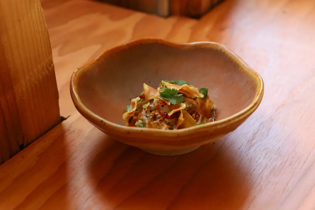 Uchiko's Koviche is a cool dish made with lobster, pickled shallots and sunchokes with puffed rice and grapefruit. (Courtesy of Hai Hospitality) 