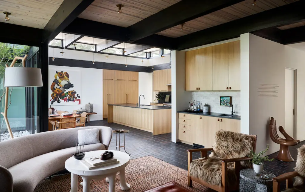Joshua Rice designed the custom oak cabinetry in the bar and kitchen areas; Jason Lenox designed the pine farmhouse table. (Photo by Stephen Karlisch and Robert Tsai)