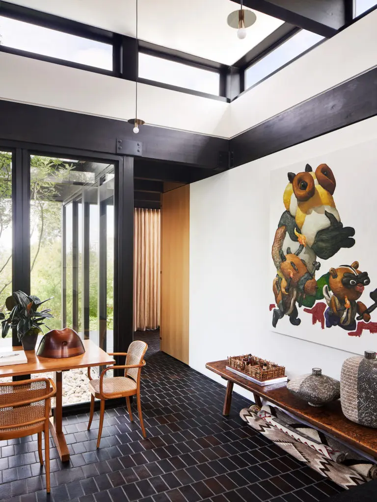 Painting by New York artist Peter Opheim. On the 19th-century American bench, a walnut box by Wendell Castle and vessels by Claude Conover, from Sputnik Modern. (Photo by Stephen Karlisch and Robert Tsai)